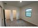 Cozy bedroom featuring a large window, carpet floors and walk-in closet at 3296 Tranquil Trl, Kissimmee, FL 34747