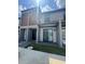 Modern townhome exterior with a well-manicured lawn and a stylish entrance at 3296 Tranquil Trl, Kissimmee, FL 34747