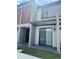 Modern townhome with a covered patio and sliding glass door for seamless indoor-outdoor living at 3296 Tranquil Trl, Kissimmee, FL 34747