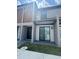 View of a modern townhome with a covered patio, sliding glass door and neutral color palette at 3296 Tranquil Trl, Kissimmee, FL 34747