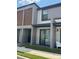 Modern townhome showcasing a covered patio with seating and a sliding glass door for natural light at 3296 Tranquil Trl, Kissimmee, FL 34747
