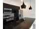 Modern kitchen boasts a spacious island, black cabinetry, and stainless steel appliances at 3296 Tranquil Trl, Kissimmee, FL 34747