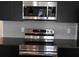 This modern kitchen has stainless steel appliances and sleek, dark cabinetry at 3296 Tranquil Trl, Kissimmee, FL 34747