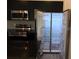 This modern kitchen features a stainless steel fridge and appliances and dark granite countertops at 3296 Tranquil Trl, Kissimmee, FL 34747