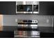 This modern kitchen has stainless steel appliances and sleek, dark cabinetry at 3296 Tranquil Trl, Kissimmee, FL 34747