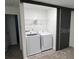 Laundry room with full size washer, dryer, and wire shelving at 3296 Tranquil Trl, Kissimmee, FL 34747