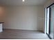 This spacious living room has wood floors and sliding glass doors that bring in natural light at 3296 Tranquil Trl, Kissimmee, FL 34747