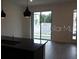 Bright living room featuring modern lighting and sliding glass doors to a balcony at 3296 Tranquil Trl, Kissimmee, FL 34747