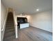 Open-concept living space with modern kitchen, island and staircase at 3296 Tranquil Trl, Kissimmee, FL 34747