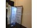 A stainless steel refrigerator with bright interior lighting is featured in the kitchen at 3296 Tranquil Trl, Kissimmee, FL 34747
