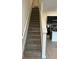 Carpeted staircase leading to the upper levels with modern design at 3296 Tranquil Trl, Kissimmee, FL 34747