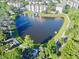 Aerial view of a lake with a fountain surrounded by lush trees and walkways at 3344 Corona Village Way # B4, Orlando, FL 32835