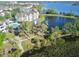 Aerial view showcasing community with pond, walking trails, water features, and beautiful landscaping at 3344 Corona Village Way # B4, Orlando, FL 32835