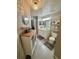Cozy bathroom featuring an ornate mirror, a white vanity, and a decorative light fixture at 3344 Corona Village Way # B4, Orlando, FL 32835