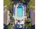 Aerial view of a community pool with lounge chairs and well-manicured landscaping at 3344 Corona Village Way # B4, Orlando, FL 32835