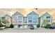 Charming townhome complex with colorful facades and attached garages in a desirable community at 3344 Corona Village Way # B4, Orlando, FL 32835