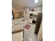 Bright kitchen features granite countertops, stainless steel appliances, and white cabinetry at 3344 Corona Village Way # B4, Orlando, FL 32835