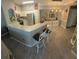 Bright kitchen with white cabinets, granite counters, and bar seating at 3344 Corona Village Way # B4, Orlando, FL 32835