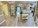 Open living room flowing into kitchen with hardwood floors and natural light at 3344 Corona Village Way # B4, Orlando, FL 32835