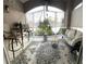 Screened patio with comfortable seating and a view of the serene surroundings at 3344 Corona Village Way # B4, Orlando, FL 32835