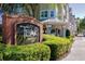 Exterior view of Teak Neighborhood Grill sign with lush landscaping at 3344 Corona Village Way # B4, Orlando, FL 32835