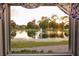 Beautiful pond view from window with fountain and lush landscaping at 3344 Corona Village Way # B4, Orlando, FL 32835