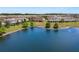 Aerial shot of the lake behind the row of townhomes, showing calm water at 1969 Portofino Meadows Blvd, Orlando, FL 32824