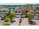 Aerial view of a multi-story home with a lake view, solar panels, and well-maintained landscaping at 1969 Portofino Meadows Blvd, Orlando, FL 32824