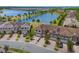 Stunning aerial view of townhomes by a serene lake, with lush landscaping and manicured lawns adding to the charm at 1969 Portofino Meadows Blvd, Orlando, FL 32824