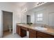Bright bathroom featuring double sinks, granite countertops, and a large mirror at 1969 Portofino Meadows Blvd, Orlando, FL 32824