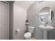 Neat half bath with toilet and pedestal sink, perfect for guests at 1969 Portofino Meadows Blvd, Orlando, FL 32824