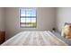 Cozy bedroom featuring a bed and a large window with a lake view at 1969 Portofino Meadows Blvd, Orlando, FL 32824