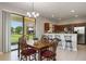 Bright dining area with backyard view and bar seating at kitchen counter, perfect for entertaining at 1969 Portofino Meadows Blvd, Orlando, FL 32824