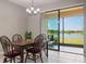Dining area with a serene lake view, offering a relaxing atmosphere for meals at 1969 Portofino Meadows Blvd, Orlando, FL 32824