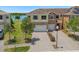 Inviting two-story townhome featuring a brick driveway, attached two-car garage, and well-maintained lawn at 1969 Portofino Meadows Blvd, Orlando, FL 32824