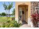 Welcoming front entrance with an open door, brick walkway, and lush landscaping at 1969 Portofino Meadows Blvd, Orlando, FL 32824