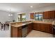 Kitchen with granite countertops and stainless steel appliances adjacent to a dining area with views at 1969 Portofino Meadows Blvd, Orlando, FL 32824