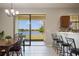 Bright eat-in kitchen with tile floors, breakfast bar, and sliding glass doors leading to a water view at 1969 Portofino Meadows Blvd, Orlando, FL 32824