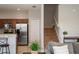 Modern kitchen with stainless steel appliances and granite countertops, adjacent to carpeted stairs at 1969 Portofino Meadows Blvd, Orlando, FL 32824