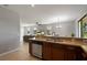 Open-concept kitchen features granite counters, stainless appliances, and a view to the living room at 1969 Portofino Meadows Blvd, Orlando, FL 32824