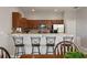 Kitchen featuring bar-style seating, stainless appliances, and wood cabinets, offering ample counter space at 1969 Portofino Meadows Blvd, Orlando, FL 32824