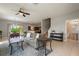Open-concept living room with tile flooring, ceiling fan, and seamless flow to the dining area and kitchen at 1969 Portofino Meadows Blvd, Orlando, FL 32824