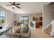 Spacious living room with tile floors, a ceiling fan, and an open layout connecting to the kitchen at 1969 Portofino Meadows Blvd, Orlando, FL 32824