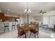 Open-concept living space with tiled flooring connecting the kitchen, dining area, and cozy seating space at 1969 Portofino Meadows Blvd, Orlando, FL 32824