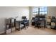Bright office space featuring a large window, two work stations, and neutral decor at 1969 Portofino Meadows Blvd, Orlando, FL 32824