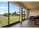 Enclosed patio offering beautiful views of the lake and lawn at 1969 Portofino Meadows Blvd, Orlando, FL 32824