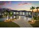 Beautiful twilight home with a three-car garage, solar panels, lush lawn and palm trees at 3209 Waterbridge Ct, Kissimmee, FL 34744