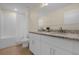 Bright bathroom with a double vanity, granite countertops, and a shower-tub combo at 4730 Coral Castle Dr, Kissimmee, FL 34746
