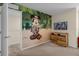 room with jungle theme, playful mural, and matching dresser at 4730 Coral Castle Dr, Kissimmee, FL 34746