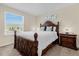 Cozy bedroom with a large bed, matching nightstand and natural light at 4730 Coral Castle Dr, Kissimmee, FL 34746